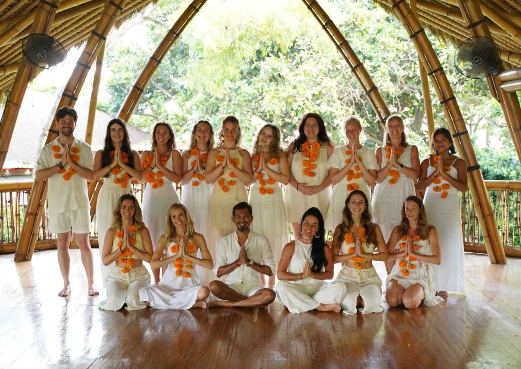 Yoga teacher training students and teachers in the bamboo shala at Power of Now Oasis in Sanur Bali after graduation