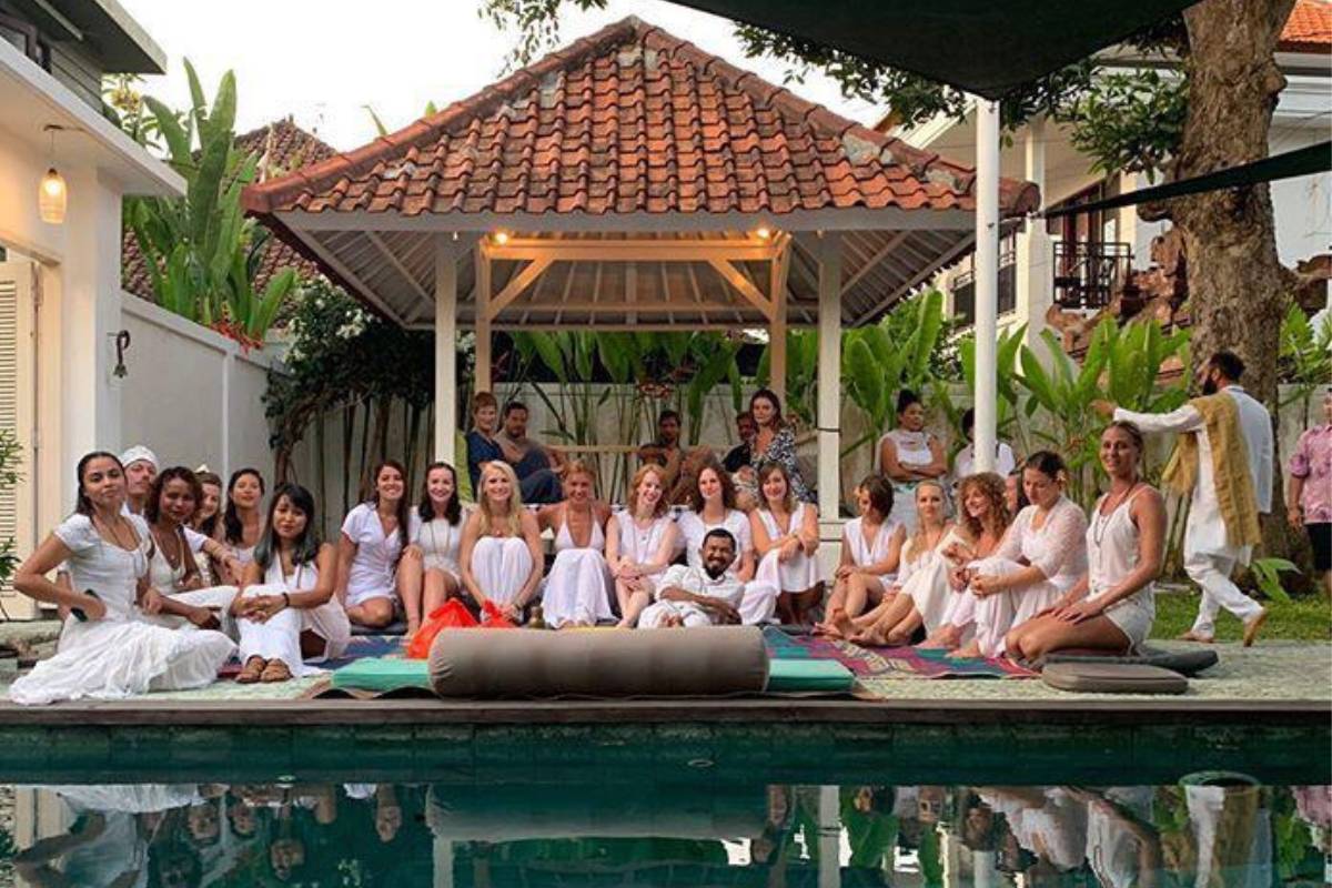 Yoga teacher training group in white by the pool at Power of Now Oasis in Sanur, Bali