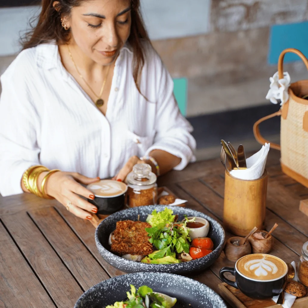 Woman having a healthy breakfast and coffee at a Genius café