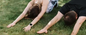 Couples Yoga Retreat Bali – Outdoor Partner Yoga in Child’s Pose, Couple practicing child’s pose together during an outdoor yoga session in Bali