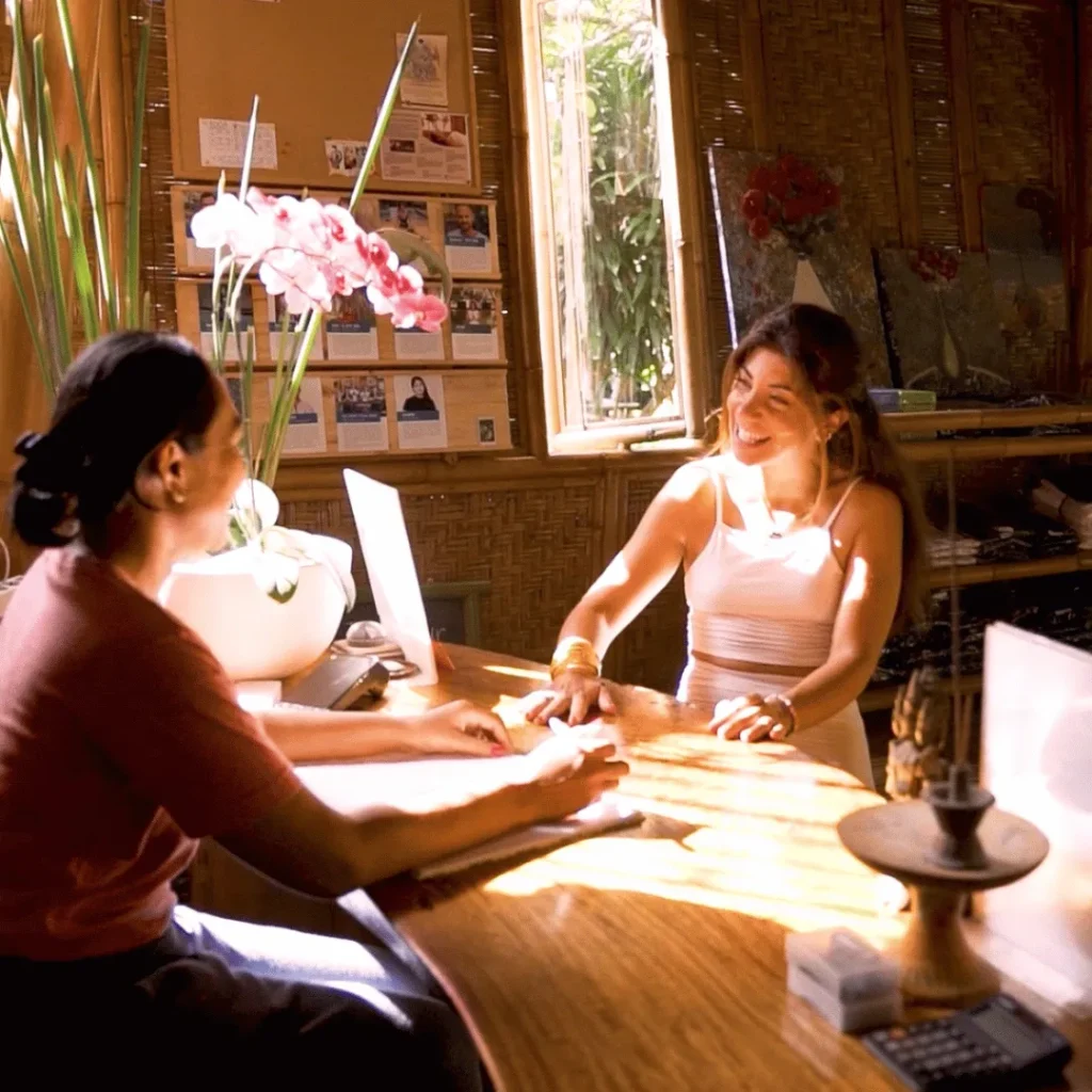 Guest warmly greeted by staff at Power of Now Oasis reception in Bali