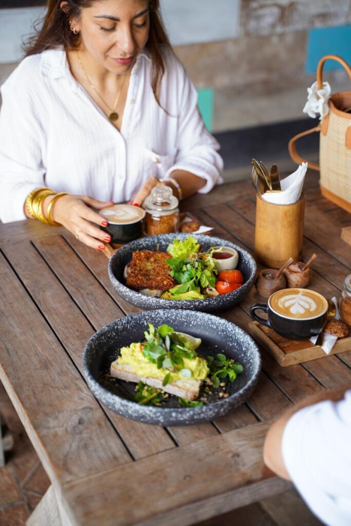 Woman having a healthy breakfast and coffee at a Genius café