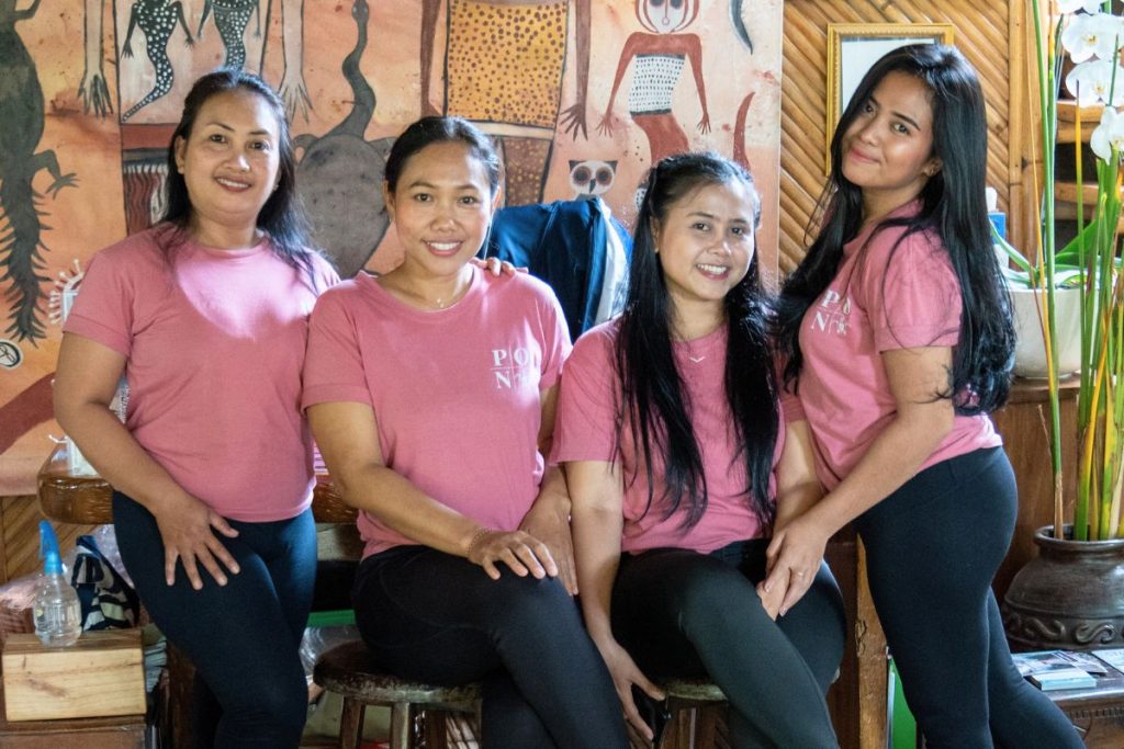 The Power of Now Oasis front office team, Mary Ayu, Yuyun, Riska and Indah, smiling together at the studio in Sanur, Bali